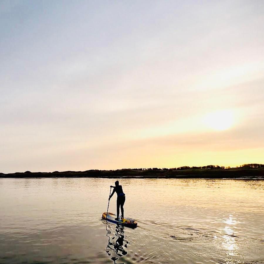 paddle boarding SUP with ocean vertical at seacliff beach in east lothian