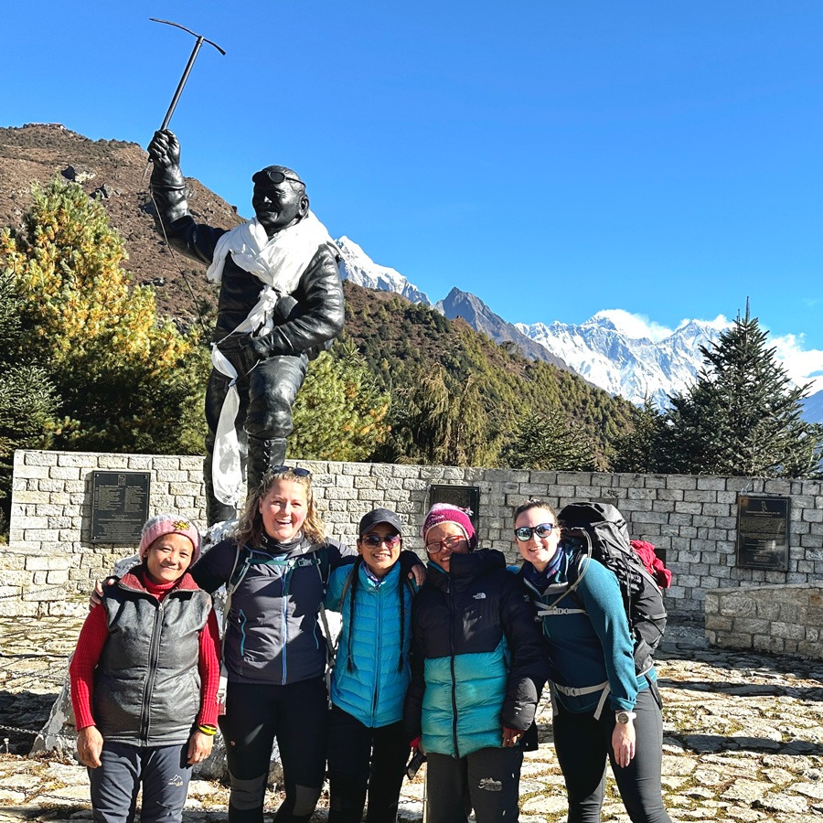 Five women standing in from of Tenzing Norgay Statue. 