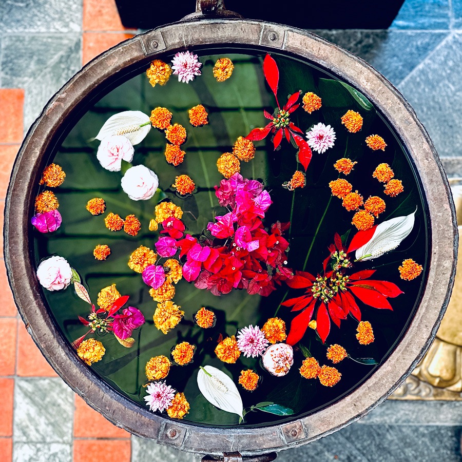 Bowl of water filled with colourful flowers in Nepali style