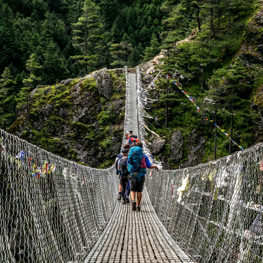 suspension bridge crossing valley in nepal